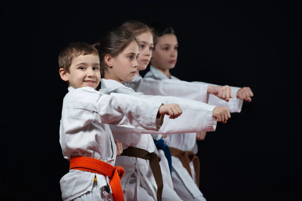 Students learning self defense skills in martial arts class.