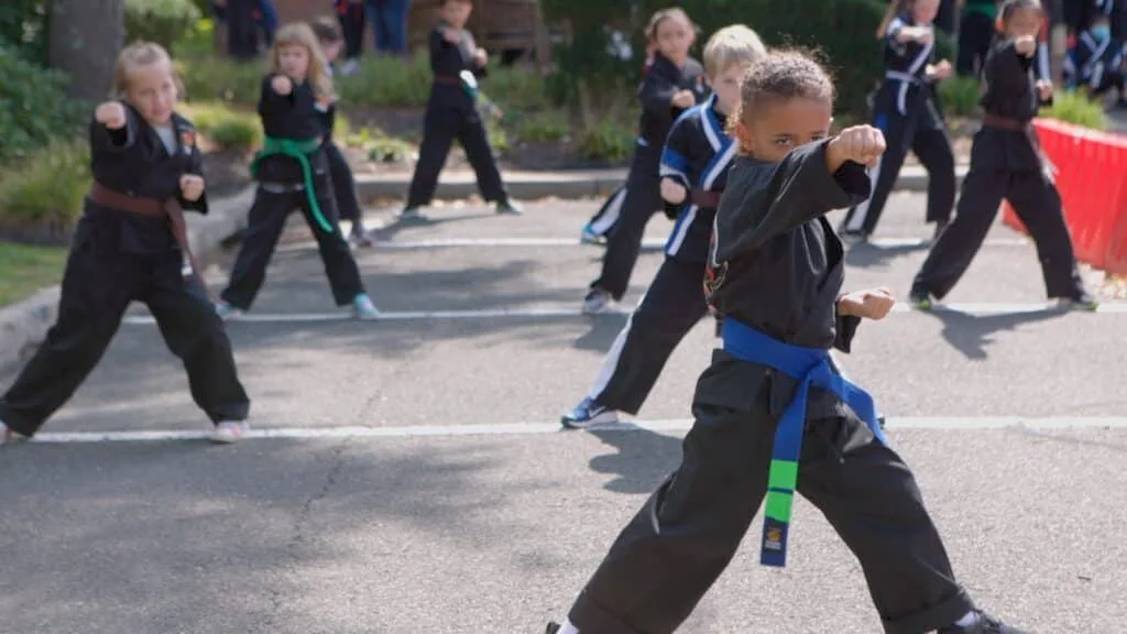 Students feeling empowered in karate for kids class.
